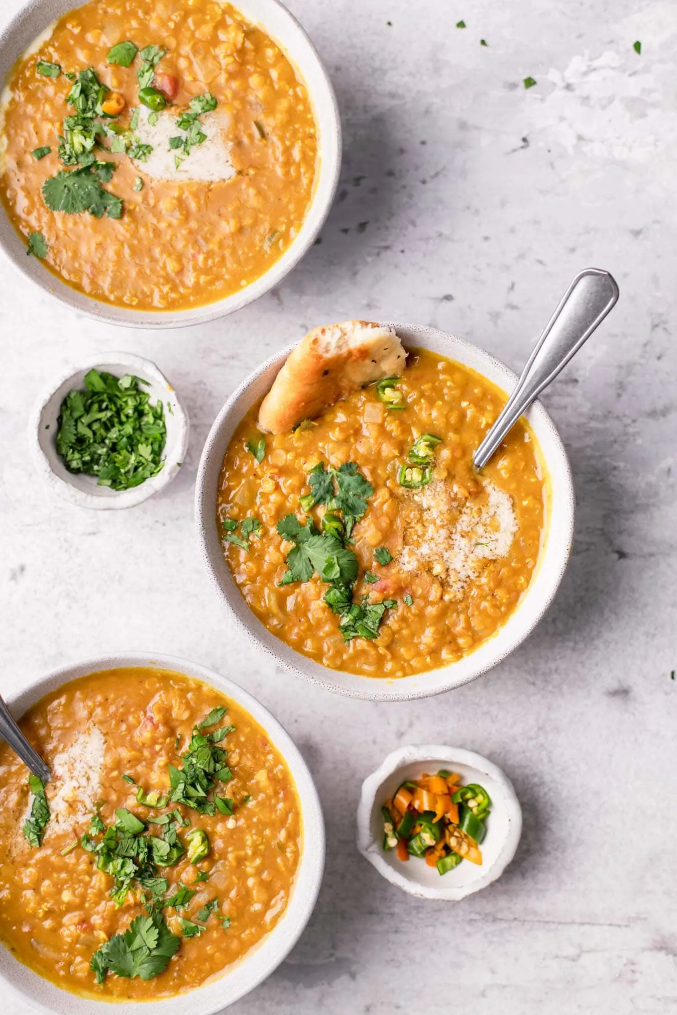 three bowls of tamarind red lentil soup