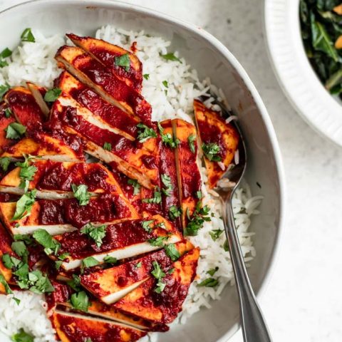 overhead view close up of the chipotle barbecue baked tofu served over rice, some collard greens on the side