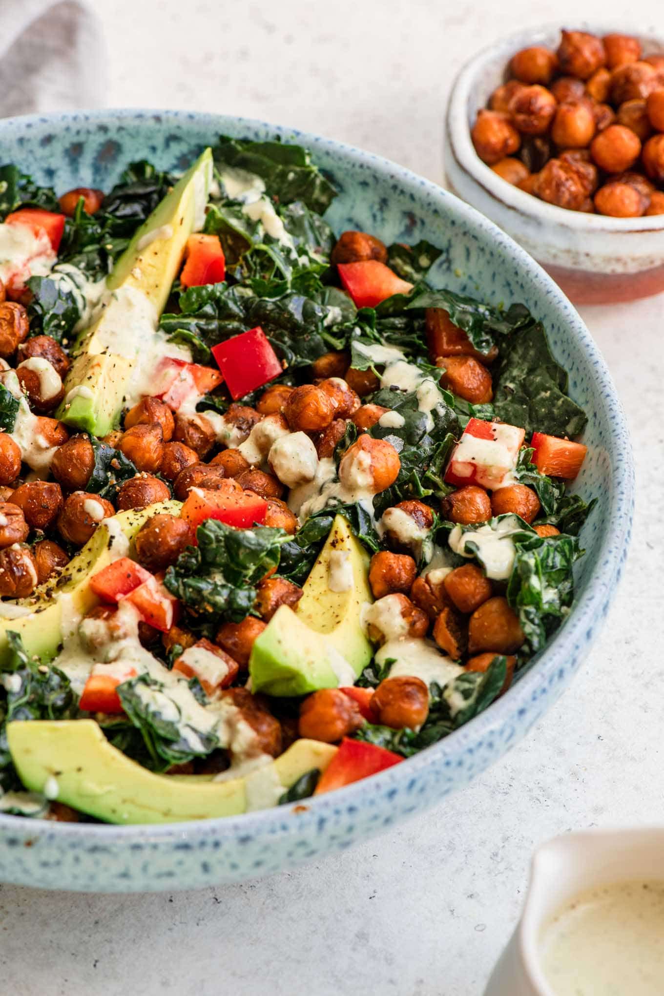 salad served in a blue bowl with extra smoky chickpeas on the side