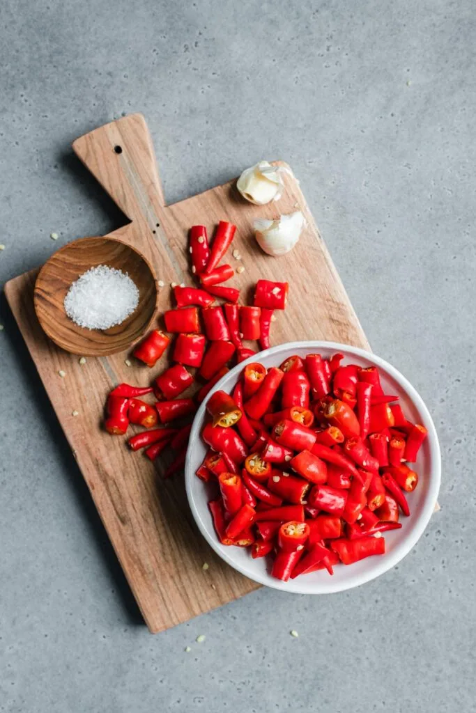 chopped cayenne peppers , garlic, and salt on cutting board