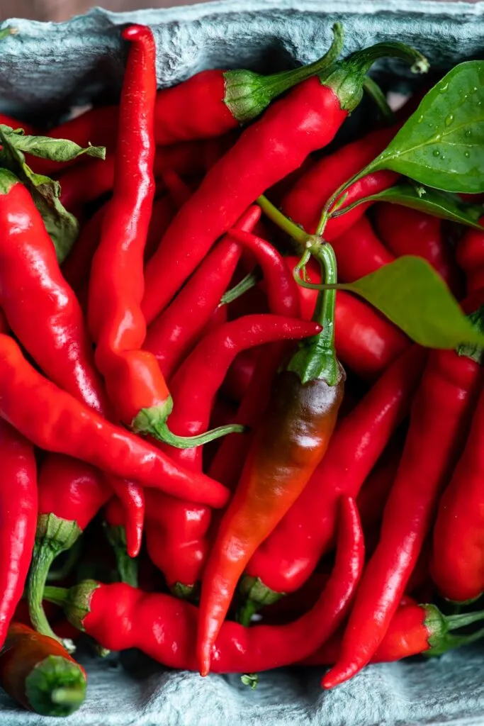 cayenne peppers in green produce pint container