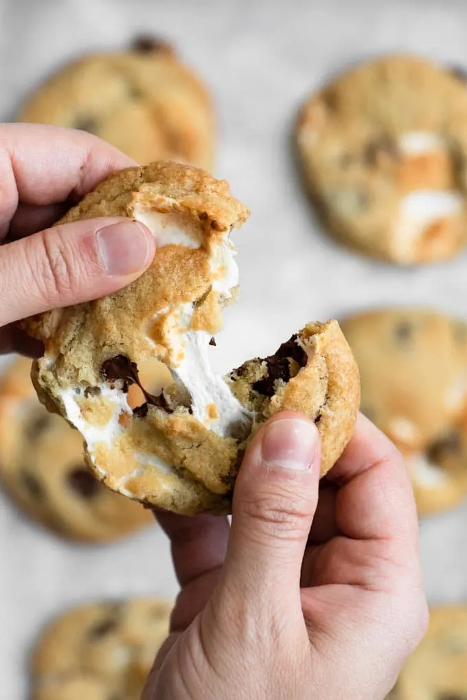 pulling apart a cookie and showing the marshmallow stretch