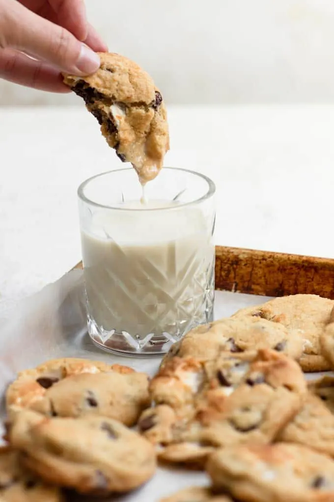 dipping a cookie into a glass of milk