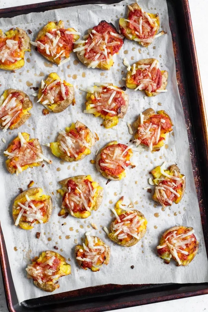 smashed potato pizzas just out of the oven, showing the melted cheese and crispy edges