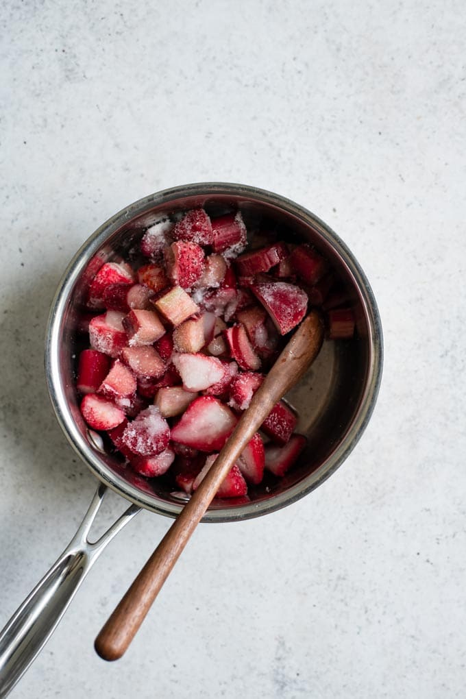 strawberry rhubarb with sugar in a pot to cook into a compote