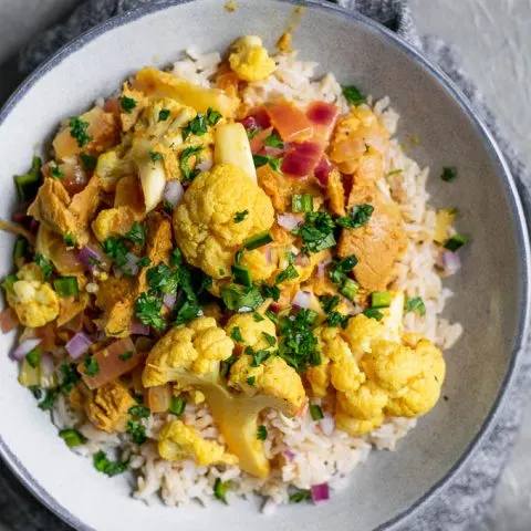 tandoori cauliflower and seitan with a garnish of cilantro served over basmati rice