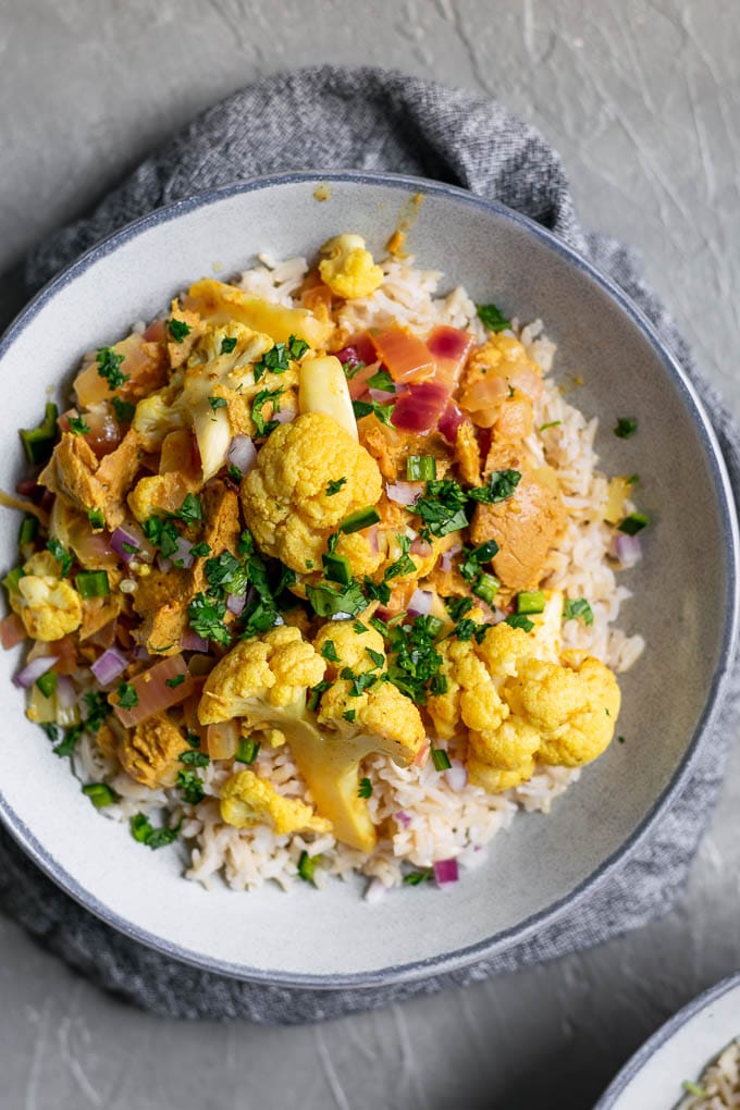 tandoori cauliflower and seitan with a garnish of cilantro served over basmati rice