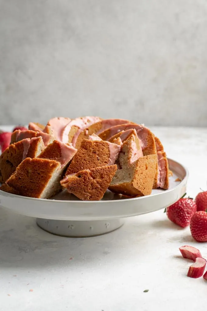 three slices of the almond rhubard bundt cake cut and laying at an angle cake