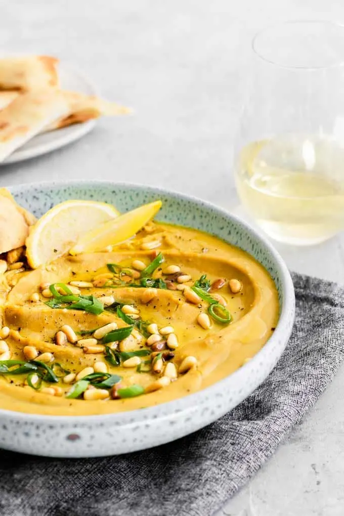 Mediterranean yellow split pea spread, favosalata, served with lemon wedges and flatbread and a glass of white wine