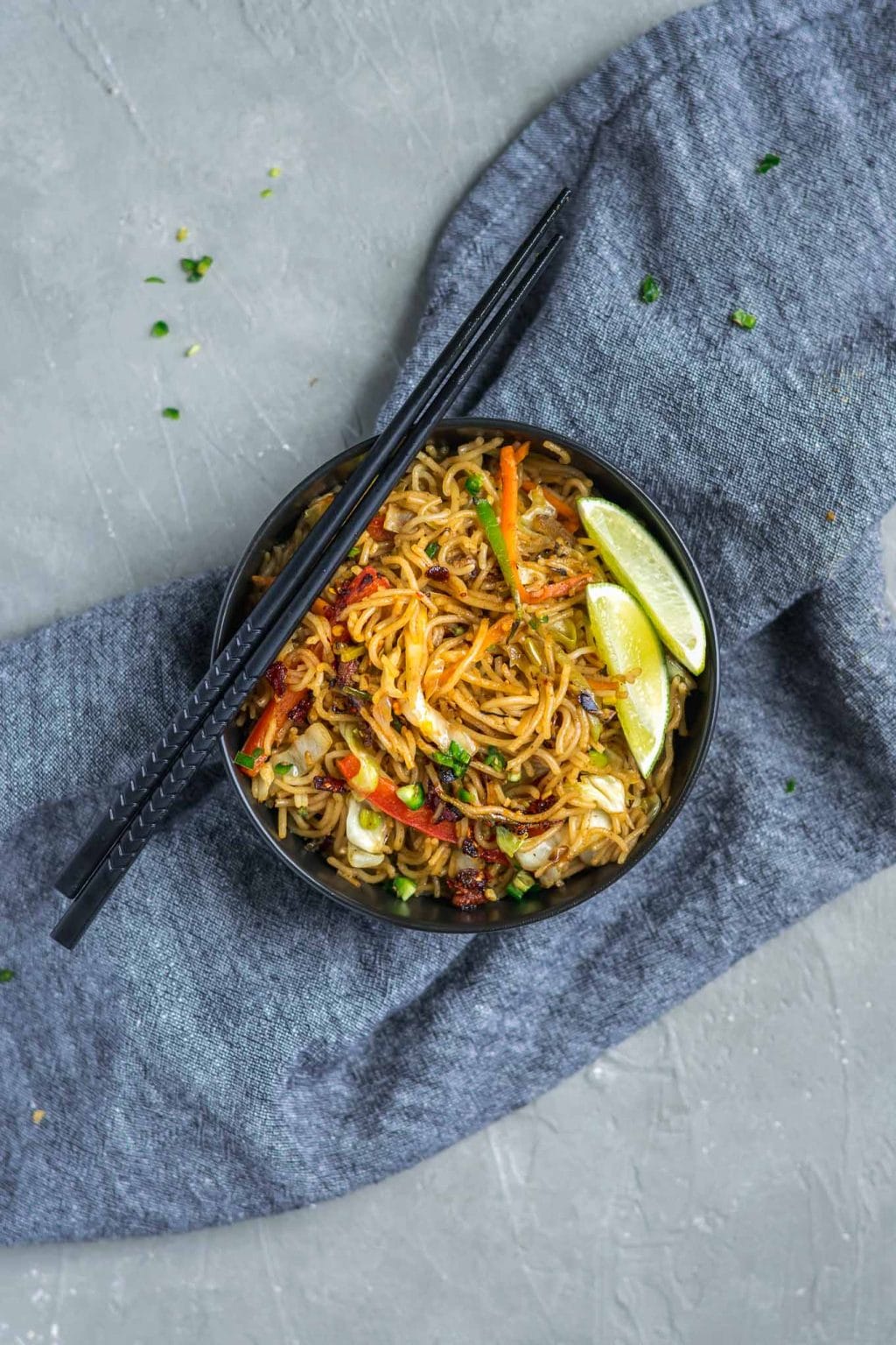 vegan singapore noodles with lime wedges