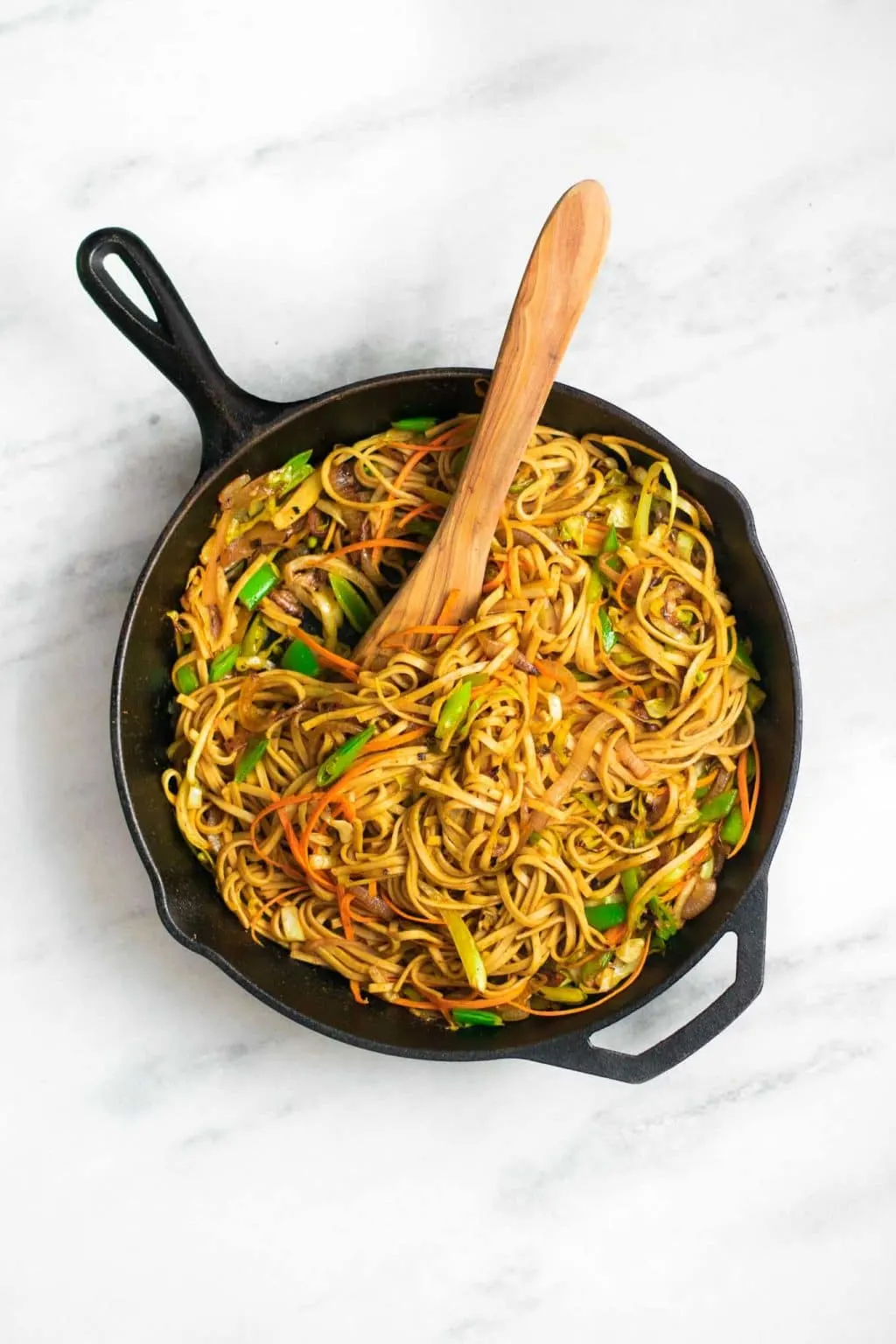 vegan singapore noodles made not traditionally with udon noodles in a cast iron skillet