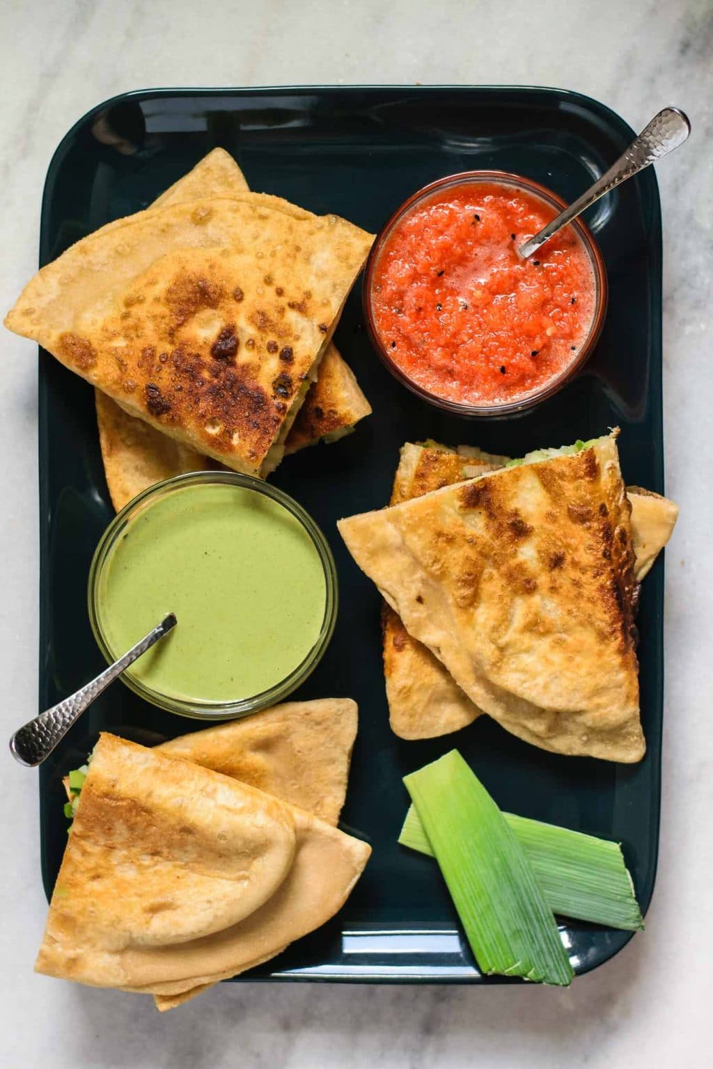 leek bolani served with coriander chutney and red pepper chutney