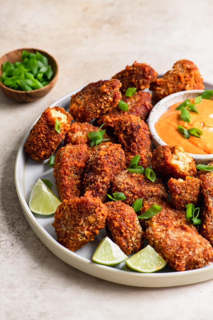 vegan gochujang tempeh wings with green onion garnish