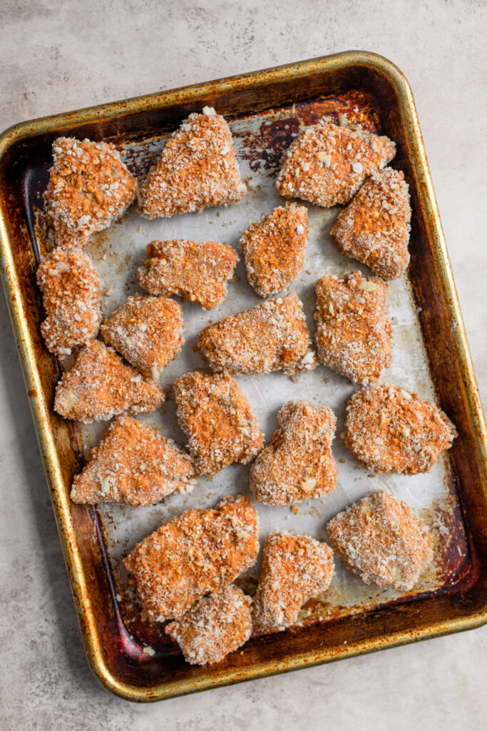 breaded tempeh wings on a baking tray before cooking