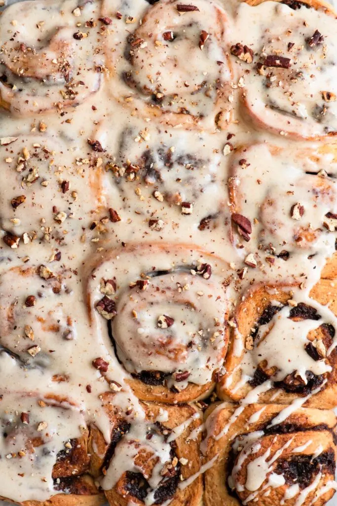 overhead closeup of frosted cinnamon rolls