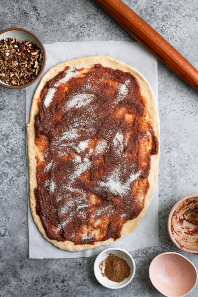 apple butter spread over dough and sugar sprinkled on top