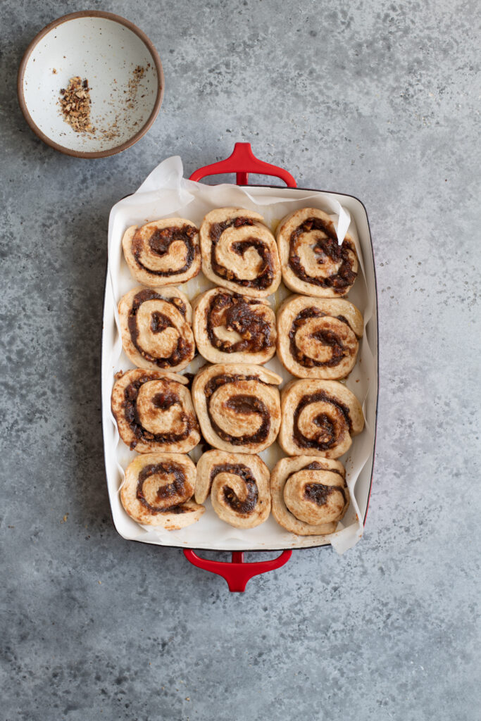 cinnamon rolls in baking dish after rising and before baking