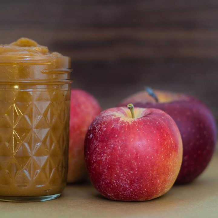 apple butter in jar with apples in background