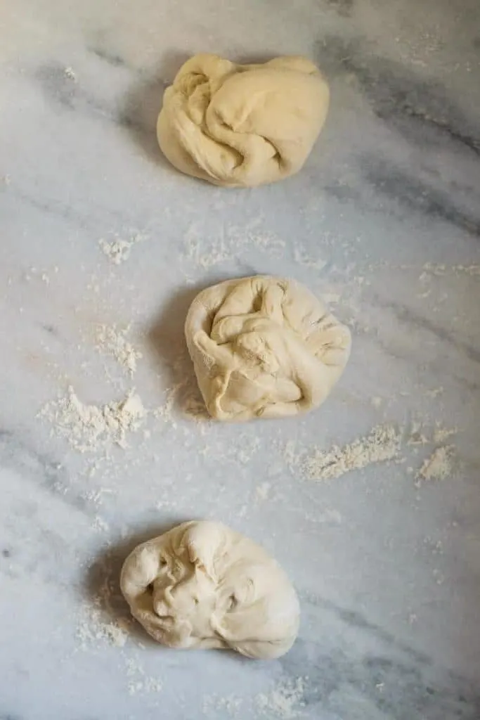 shaping the pizza dough into dough balls