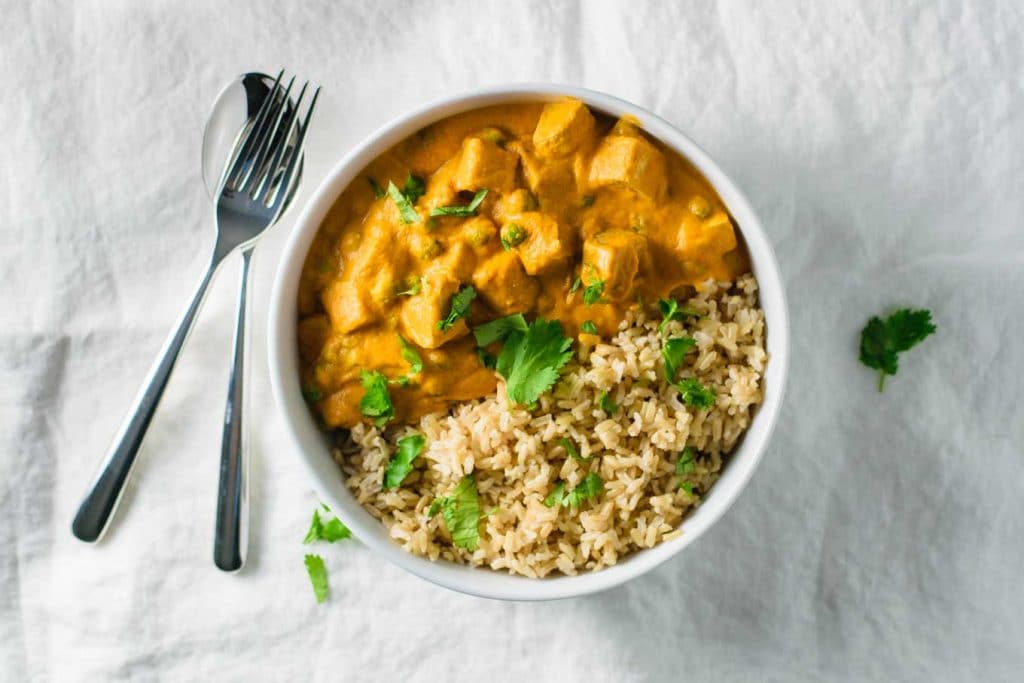 vegan mattar tofu paneer served with cilantro and lime