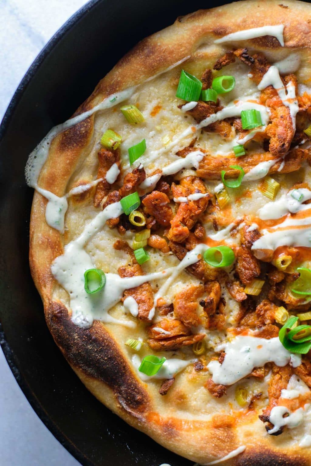 buffalo soy curl pizza with ranch dressing drizzle