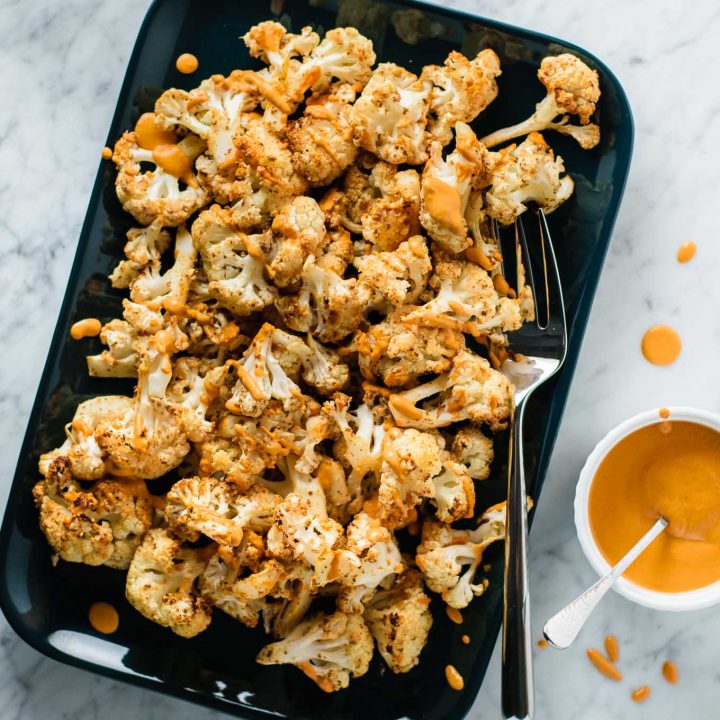 mustard roasted cauliflower with roasted red pepper drizzle