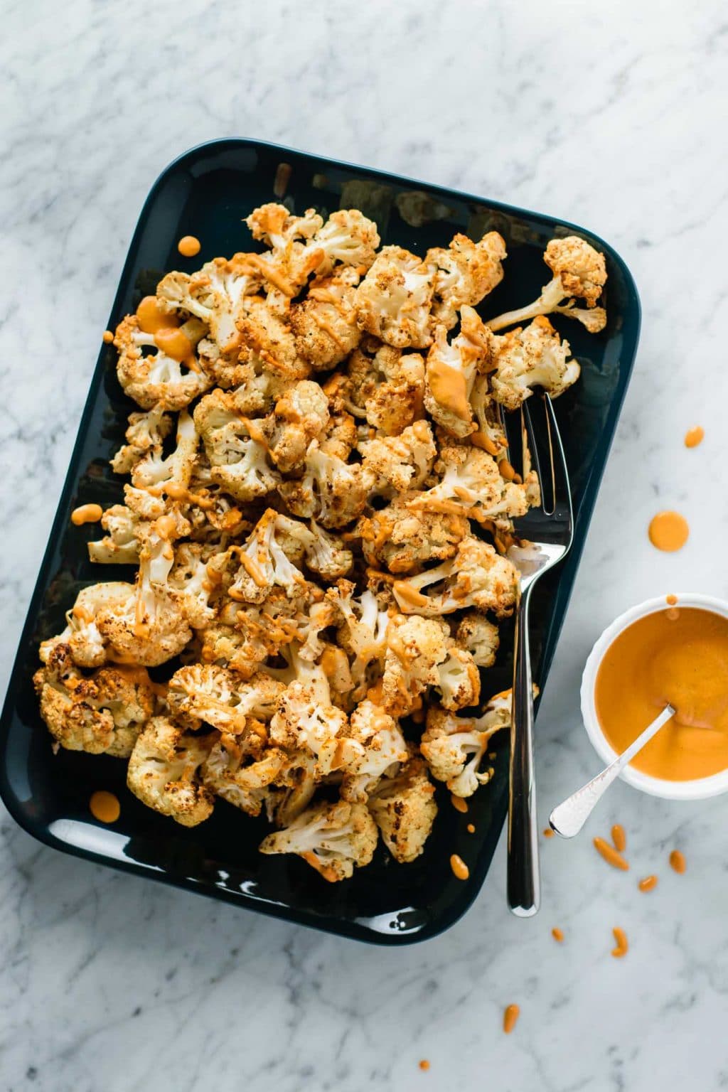 mustard roasted cauliflower with roasted red pepper drizzle