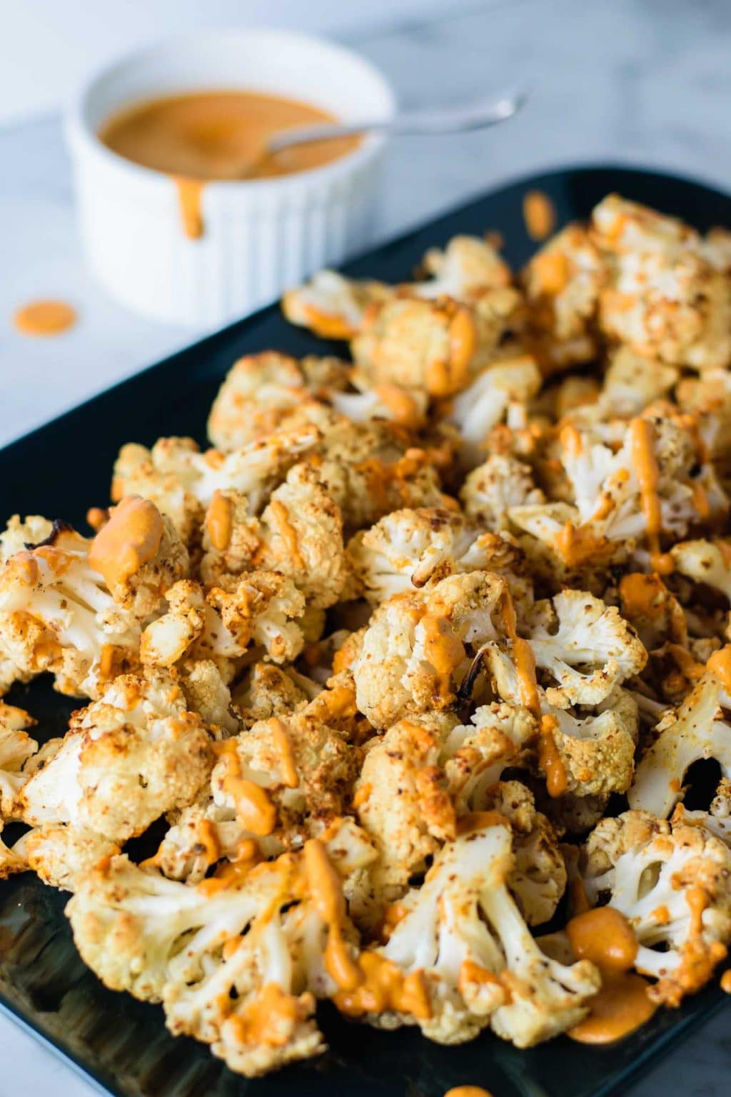 mustard roasted cauliflower with roasted red pepper drizzle