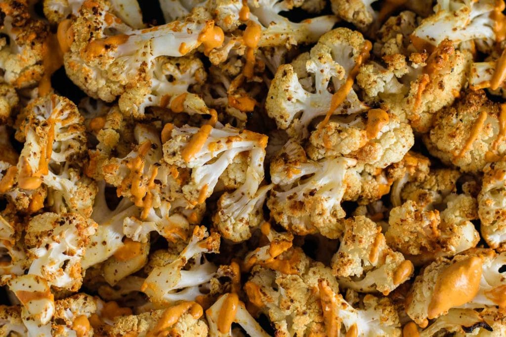 mustard roasted cauliflower with roasted red pepper drizzle