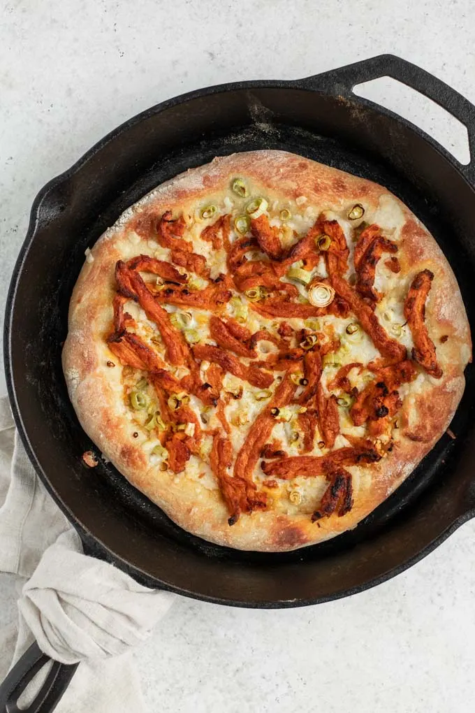 vegan buffalo pizza after baking in cast iron skillet