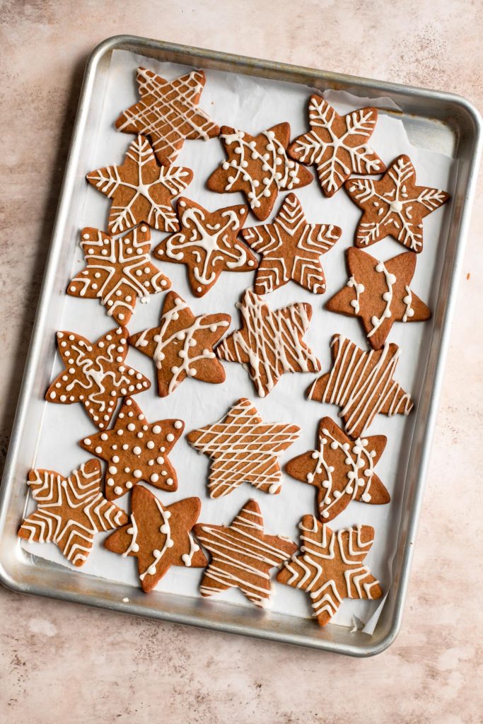 decorated wishing cookies on a parchment lined baking tray