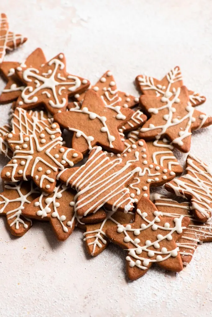 vegan wishing cookies stacked on a powdered sugar dusted surface