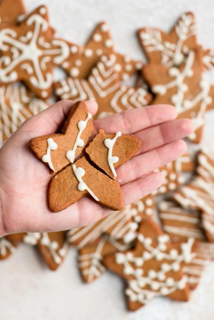 a star-shaped wishing cookie broken into three pieces on the palm of a hand