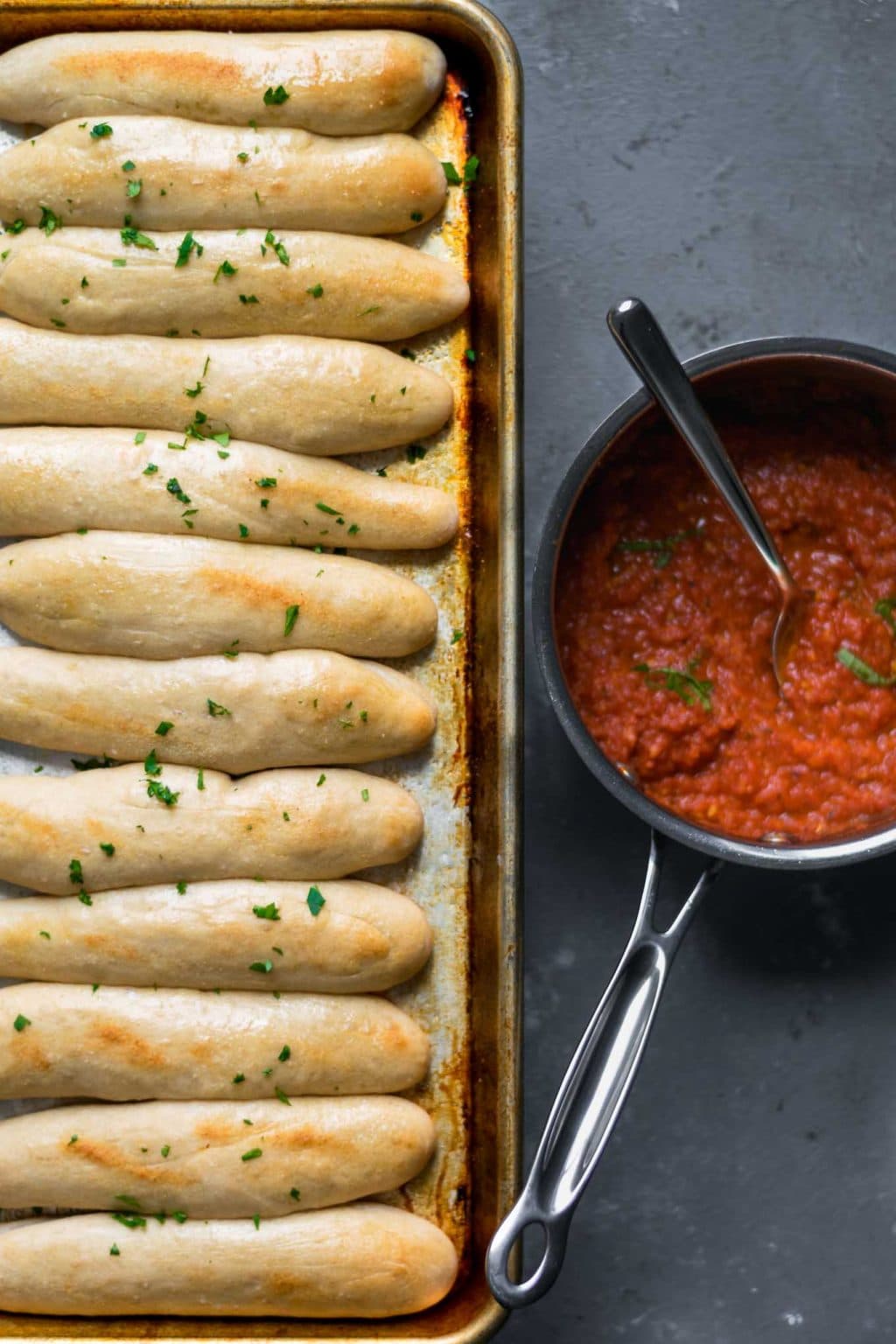 quick and easy homemade breadsticks with spicy marinara sauce for dipping