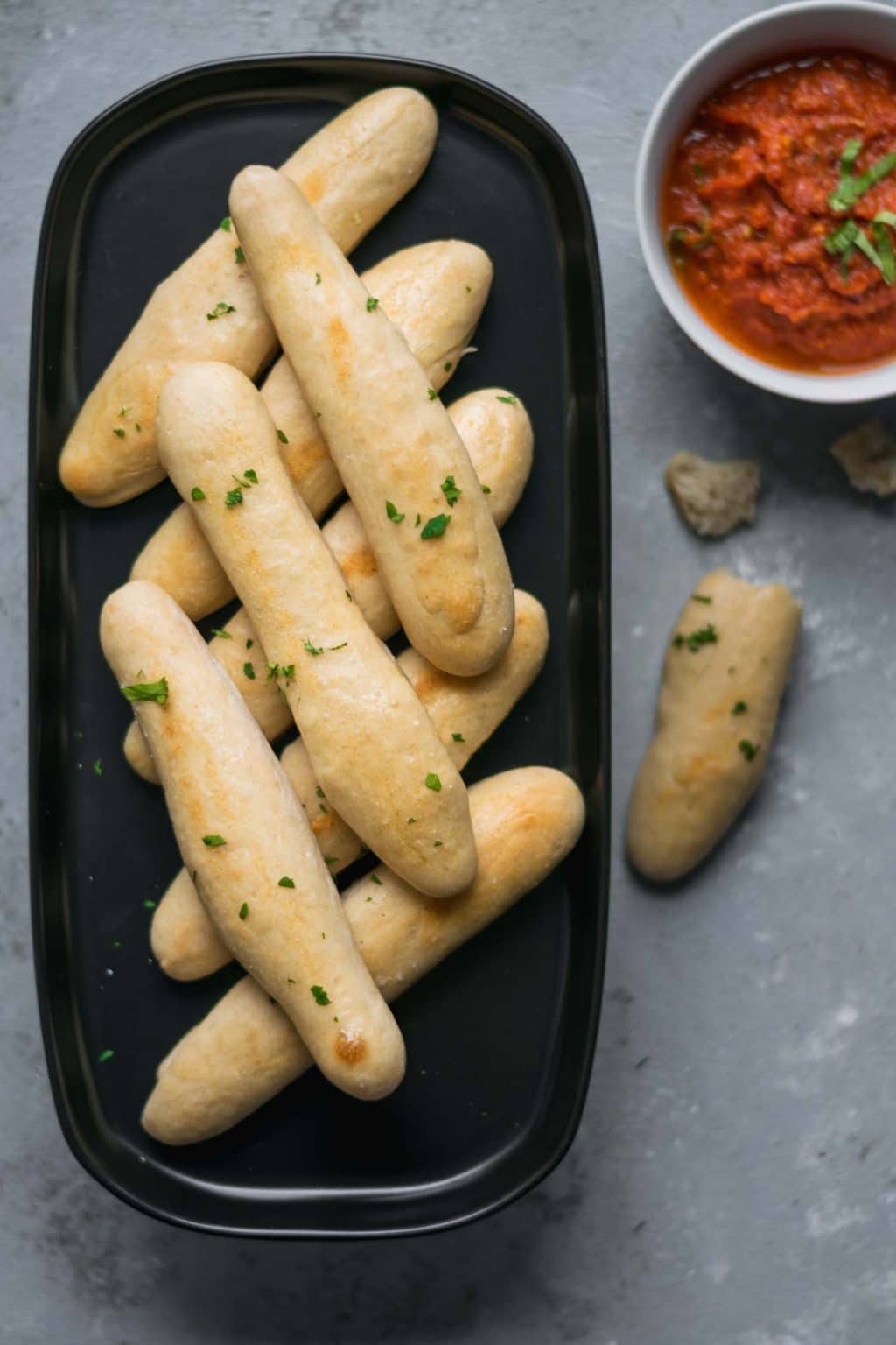 quick and easy homemade breadsticks with spicy marinara sauce for dipping