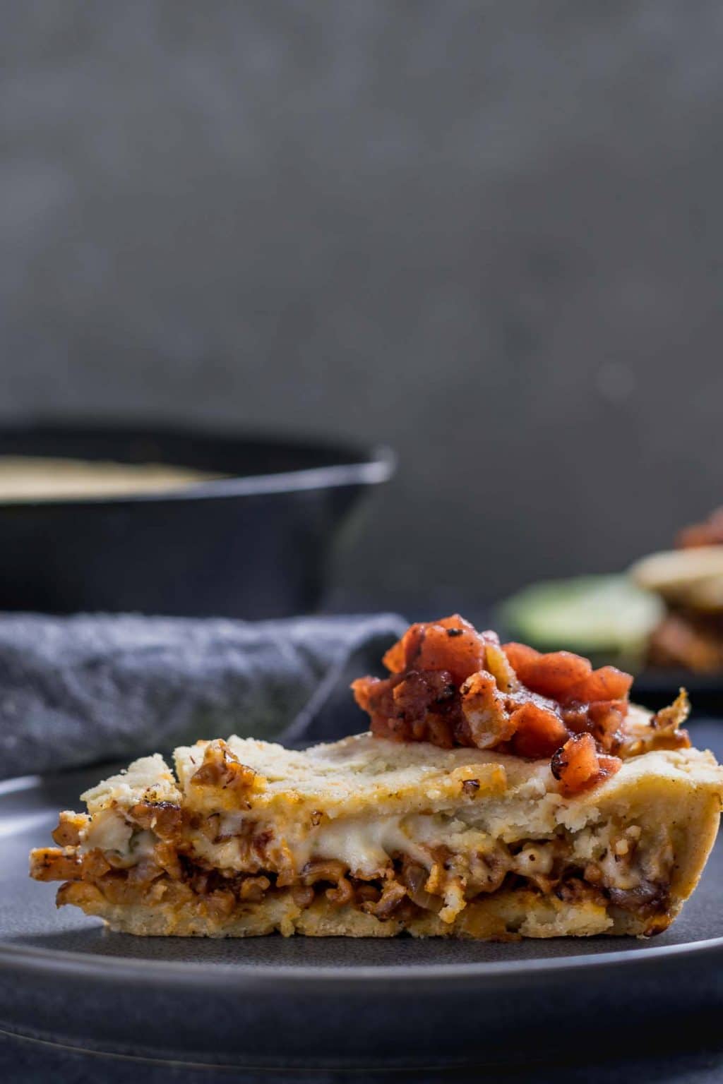 Sideview of a slice of the vegan chipotle seitan cheese tamale skillet pie