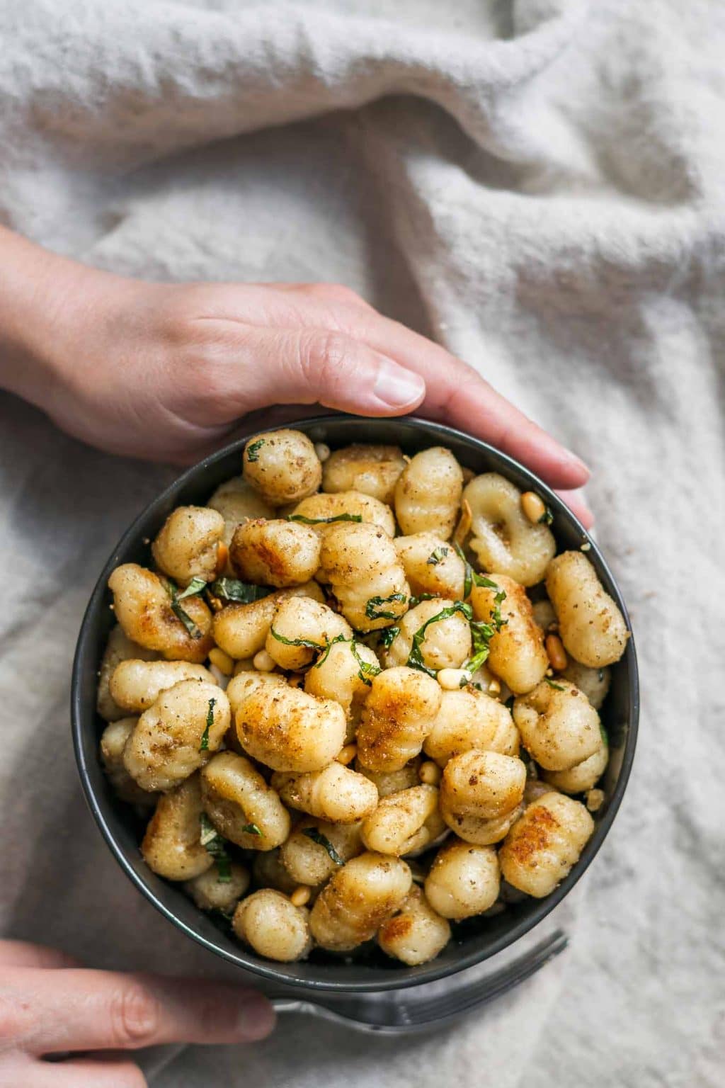 grabbing a bowl of vegan brown butter gnocchi