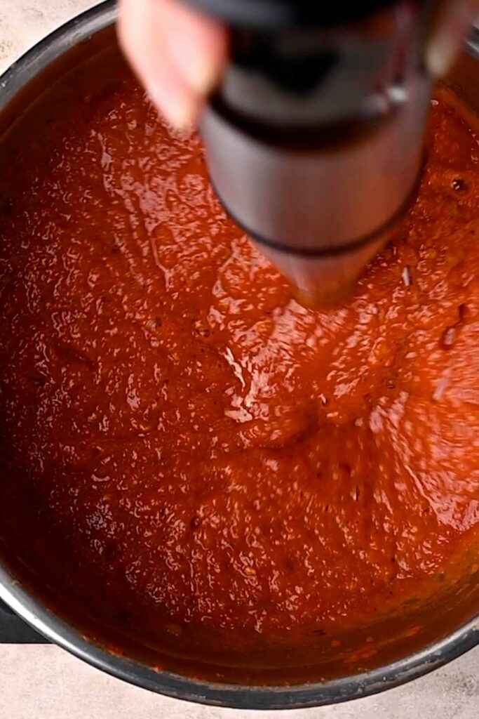 blending the arrabbiata with an immersion blender