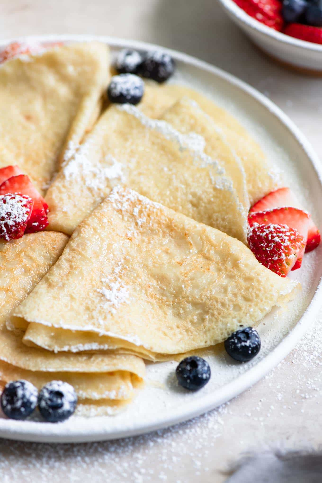 close up of easy vegan crepes served with berries