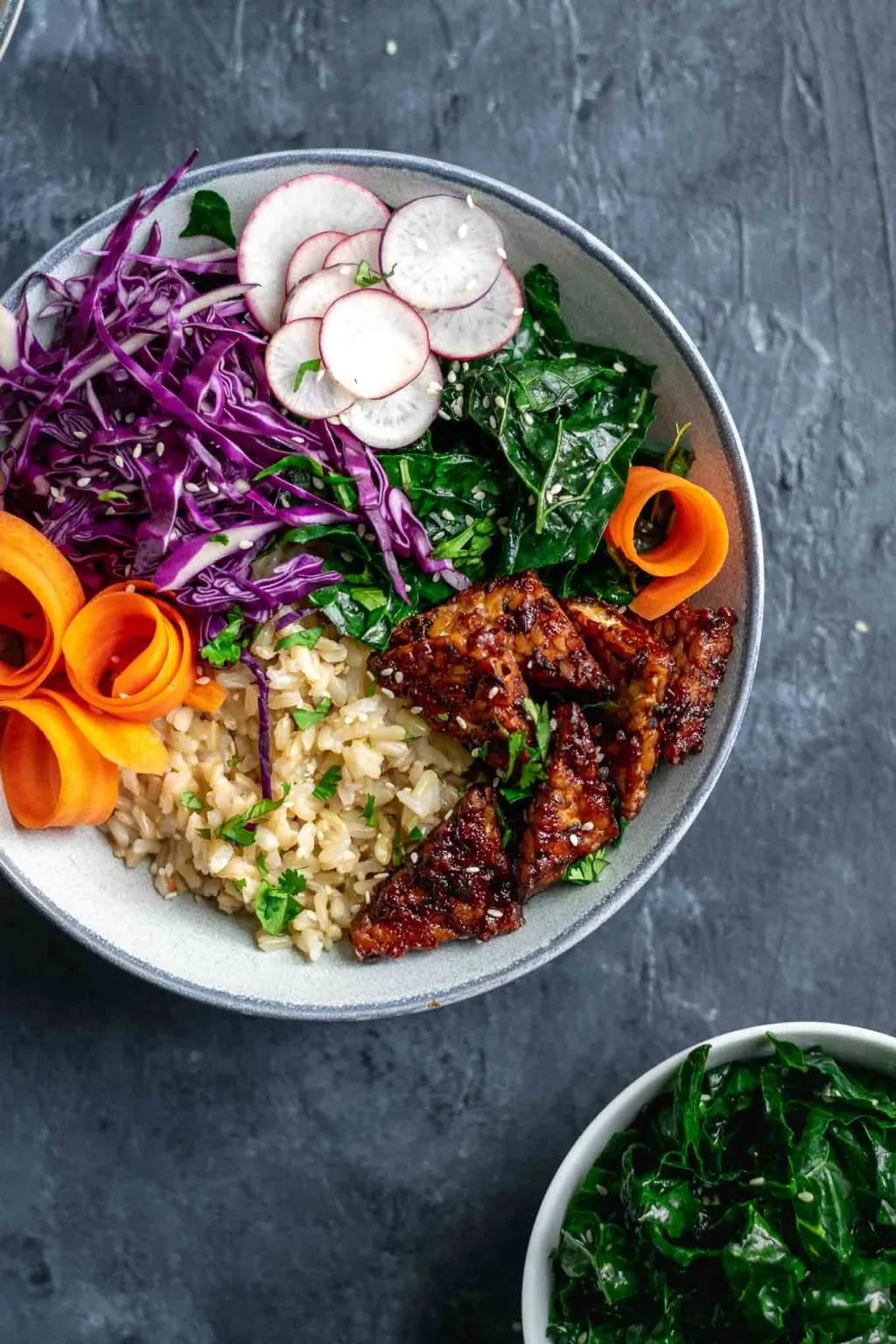 hoisin glazed tempeh bowls with sesame kale, thinly sliced carrots, radishes and red cabbage