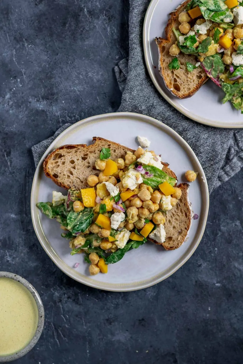 Curried chickpea and mango salad with vegan queso fresco served over a slice of toast.