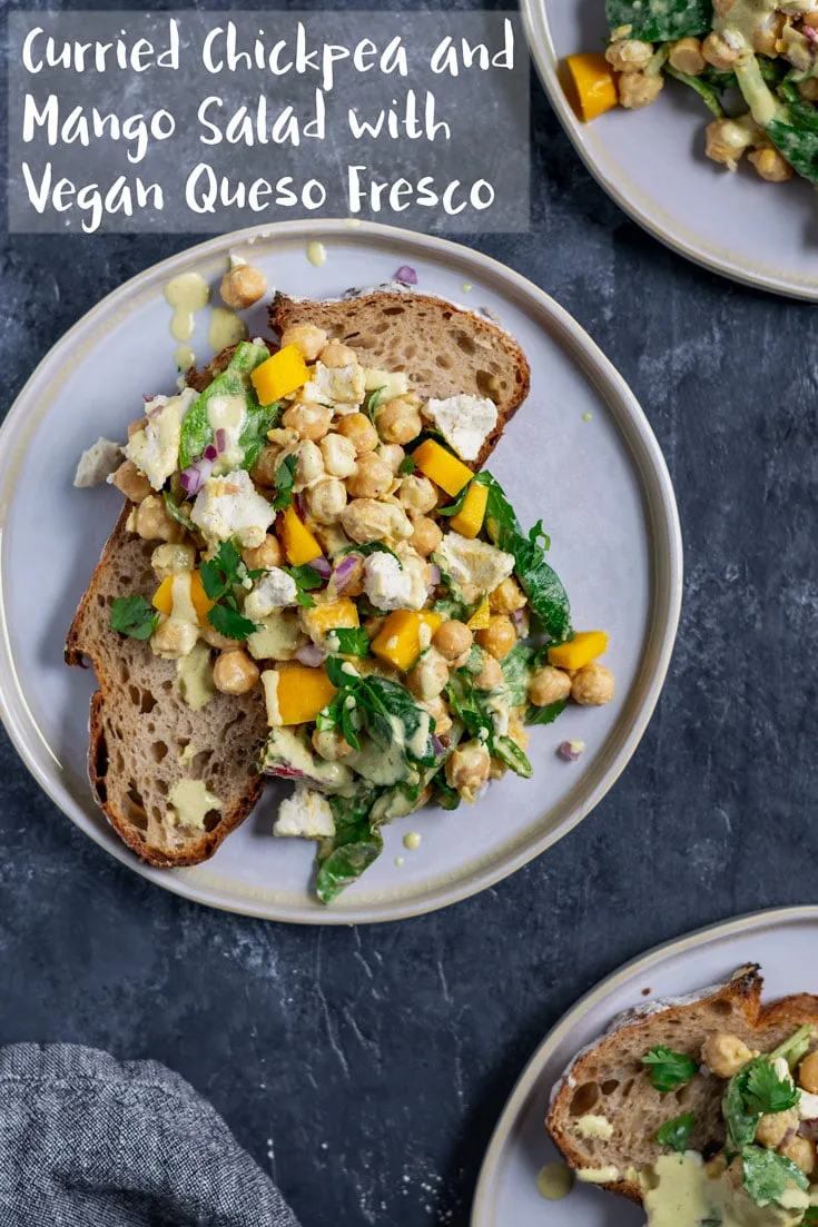 Chickpeas and ripe mango are tossed in a creamy curry dressing along with some baby greens and vegan queso fresco. Perfect for serving alongside some crusty bread, in a sandwich, or as a side salad. | thecuriouschickpea.com #vegan #salad #chickpeas #mango
