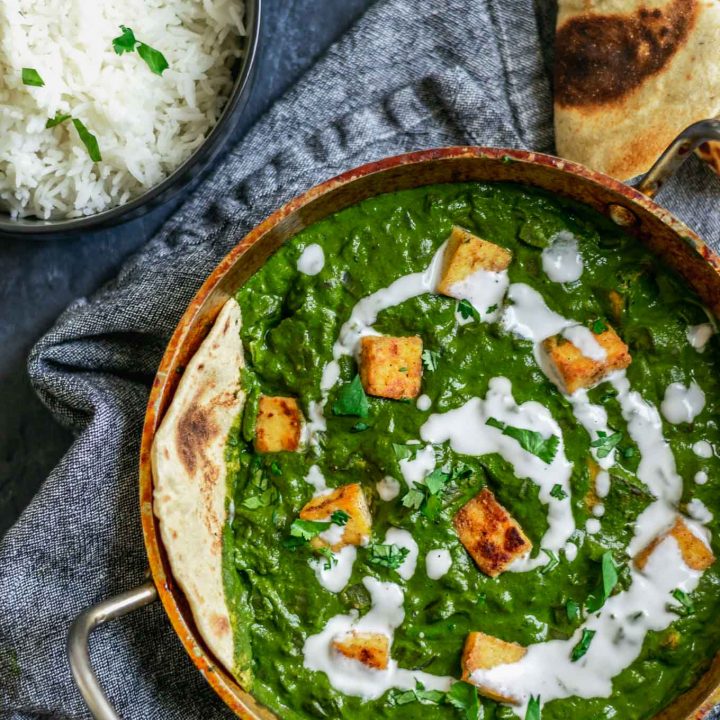 vegan palak tofu paneer with a drizzle of coconut milk and served with fresh chapati bread and basmati rice with extra tofu paneer on the side