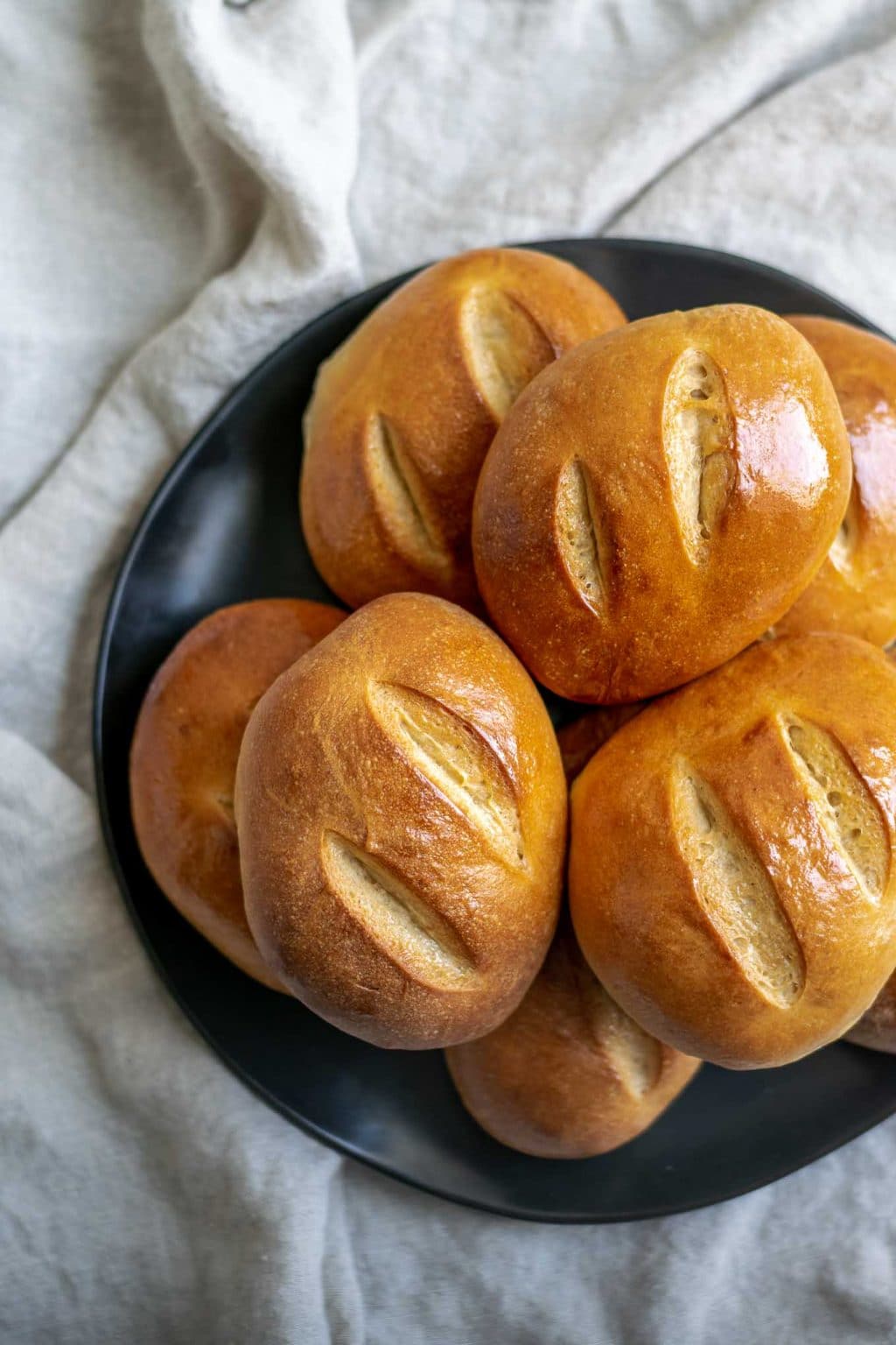 the ultimate homemade sandwich rolls on stacked on a plate, overhead view