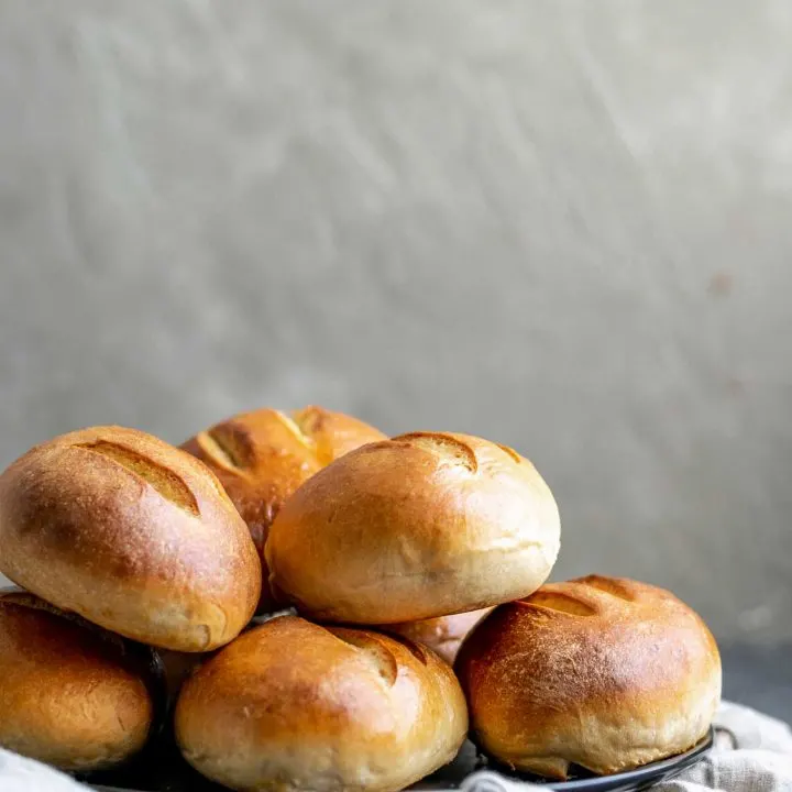 ultimate homemade sandwich rolls stacked on a plate, side view