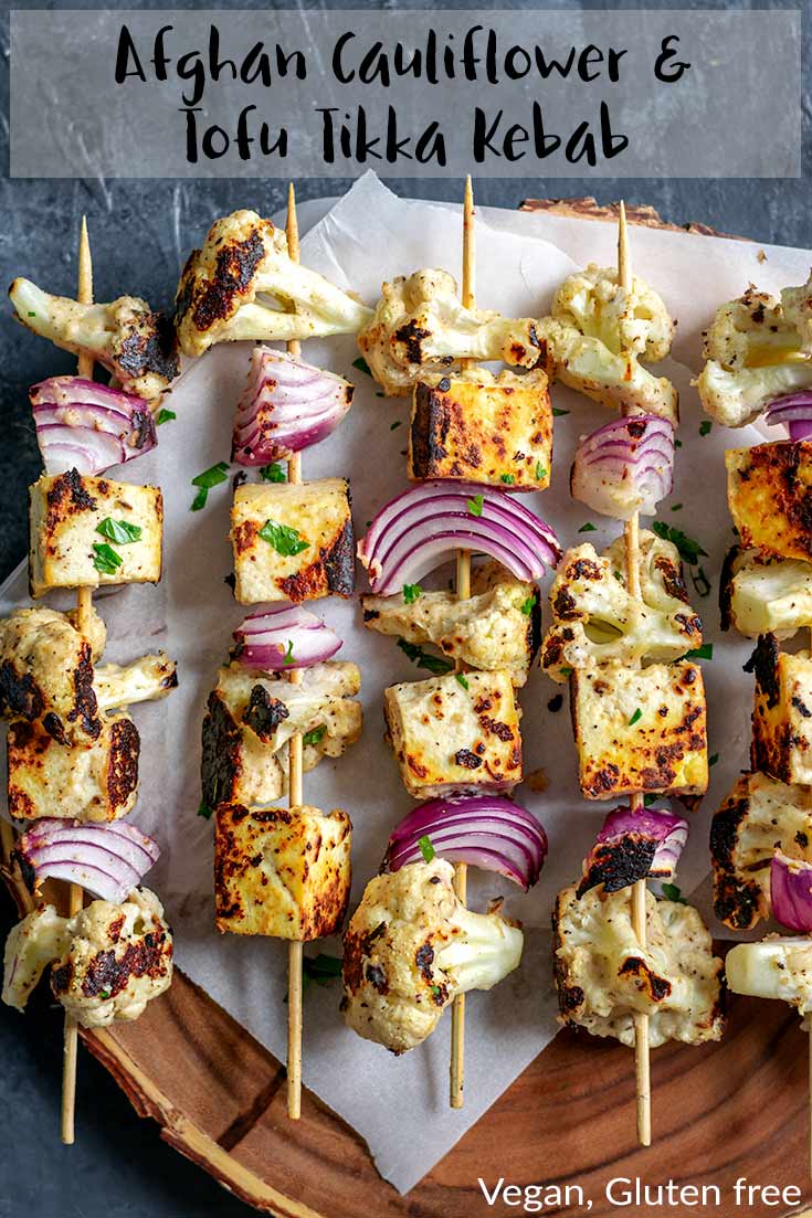 Cauliflower florets and tofu are marinated in a vegan spiced yogurt sauce then grilled until smokey and charred for a delicious easy meal, perfect for summertime barbecues! Eat as is, or serve with rice or in a wrap. | thecuriouschickpea.com #vegan #afghan #glutenfree #tikka #kebab