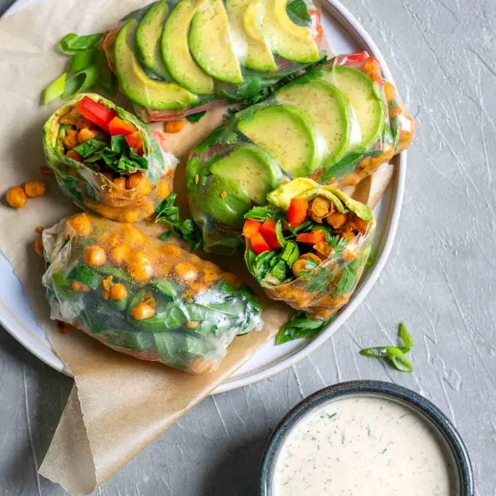 Buffalo chickpea rice paper wraps with tahini ranch dip, served on a plate with the dip in a bowl