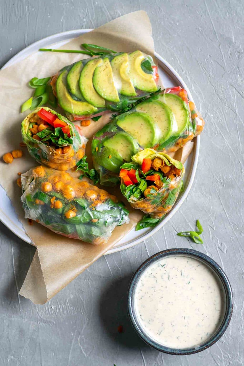 Buffalo chickpea rice paper wraps with tahini ranch dip, served on a plate with the dip in a bowl