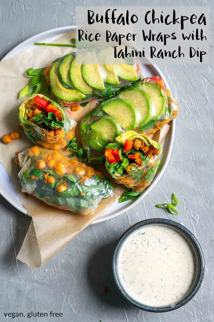 These salad wraps are stuffed with spicy pan roasted buffalo chickpeas, avocado, shredded collard greens, red bell pepper, and fresh herbs. They're rolled up in rice paper then dipped in a tahini ranch dressing, they're the perfect light meal or snack on the go. They're fresh tasting and perfect for summer. | thecuriouschickpea.com #vegan #healthy #glutenfree