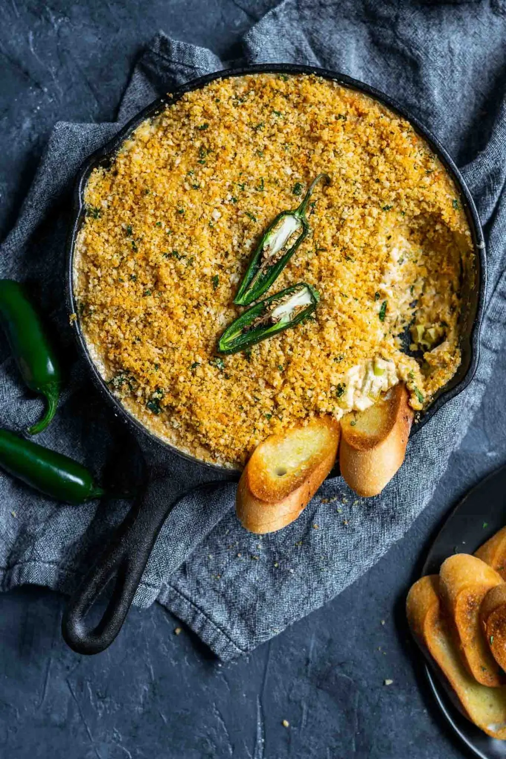 vegan jalapeño popper dip baked in a cast iron skillet